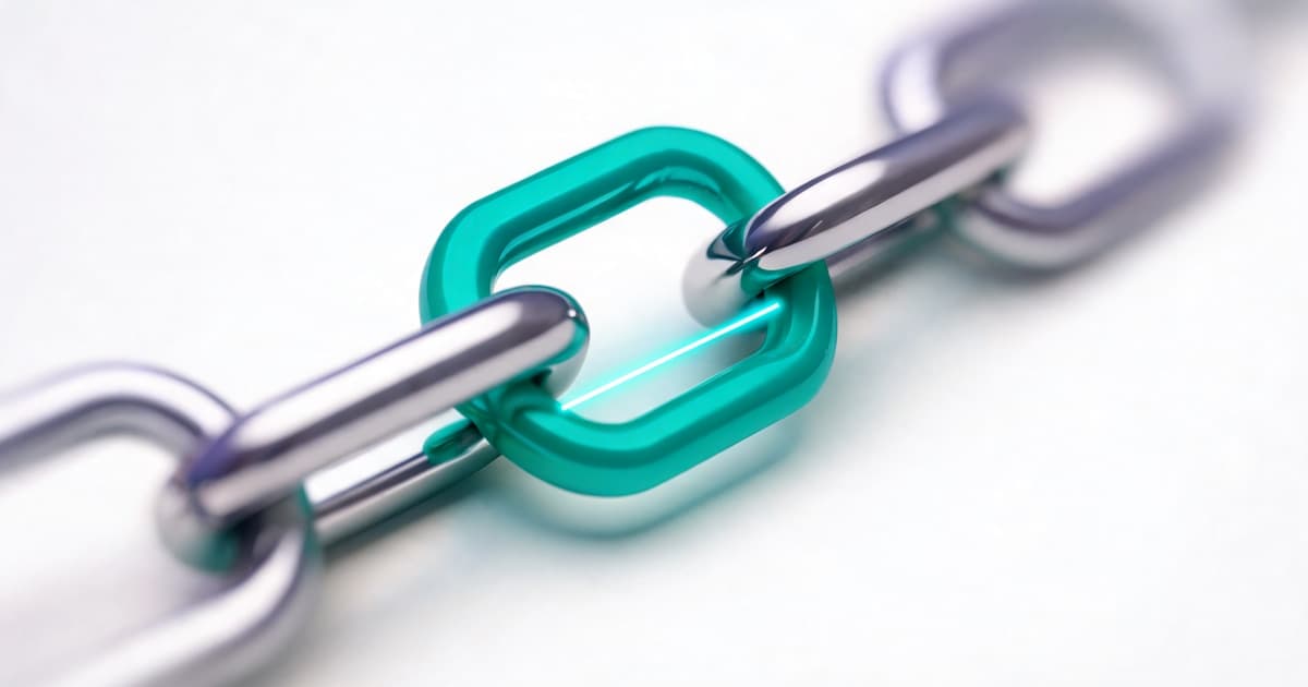 A close view of two chain links interlocking, illustrating the point where two systems connect.